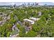 Aerial view of the community with mature trees and skyline in the background at 430 Queens Rd # 111, Charlotte, NC 28207