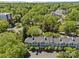 Aerial view of gray buildings with parking in a community surrounded by mature trees at 430 Queens Rd # 111, Charlotte, NC 28207