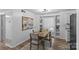 Open dining area with a modern table and chairs, seamlessly connected to the kitchen and living room at 430 Queens Rd # 111, Charlotte, NC 28207