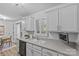 Bright kitchen featuring white cabinets, grey countertops, and a view into the dining area at 430 Queens Rd # 111, Charlotte, NC 28207
