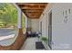 Inviting covered porch with seating area, view of the street, and clear unit number, enhancing the entrance at 430 Queens Rd # 111, Charlotte, NC 28207