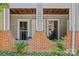 Charming porch with brick accents, lovely plants, and clear unit number signage offers curb appeal at 430 Queens Rd # 111, Charlotte, NC 28207