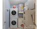 Utility room with a stacked washer and dryer and a hot water heater at 430 Queens Rd # 111, Charlotte, NC 28207