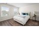 Inviting bedroom with ample natural light, featuring a comfortable bed and stylish side table at 4312 Plumeria Way, Fort Mill, SC 29707