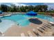 Overhead view of community pool with tanning ledge, lap lanes, lounge chairs, and tables with umbrellas at 4312 Plumeria Way, Fort Mill, SC 29707