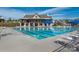 Bright community pool with a bathhouse and many lounge chairs for residents on a clear summer day at 4312 Plumeria Way, Fort Mill, SC 29707