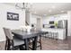 This dining area features modern lighting and a smooth transition into the bright kitchen with an open floorplan at 4312 Plumeria Way, Fort Mill, SC 29707