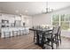 Bright dining area features a modern chandelier and an open floorplan to kitchen with white cabinets at 4312 Plumeria Way, Fort Mill, SC 29707