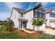 Charming two-story home with gray siding, stone accents, a well-manicured lawn, and a one-car garage at 4312 Plumeria Way, Fort Mill, SC 29707
