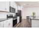 Modern kitchen with white cabinets, stainless steel appliances, and granite countertops, perfect for cooking at 4312 Plumeria Way, Fort Mill, SC 29707