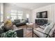 Comfortable living room with a grey leather sofa, stylish armchairs, and sleek modern furniture at 4312 Plumeria Way, Fort Mill, SC 29707