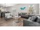 Bright and comfortable living area next to the dining area with a plush sofa, stylish armchairs and a sleek table at 4312 Plumeria Way, Fort Mill, SC 29707