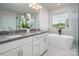 Elegant main bathroom showcasing dual sinks, a soaker tub, and white cabinetry at 4312 Plumeria Way, Fort Mill, SC 29707