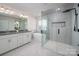 Luxurious main bathroom featuring a modern stand-alone tub, glass shower, and dual vanity sinks at 4312 Plumeria Way, Fort Mill, SC 29707