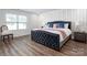 Beautiful main bedroom featuring a tufted headboard, accent wall, and lots of natural light at 4312 Plumeria Way, Fort Mill, SC 29707