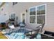 Backyard patio features outdoor seating, a grill, and a view of the surrounding townhome community at 4312 Plumeria Way, Fort Mill, SC 29707