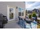 Cozy backyard patio features outdoor seating and a grill with a view of the townhome community at 4312 Plumeria Way, Fort Mill, SC 29707