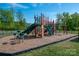 A spacious playground with climbing structures, slides, and a soft landing surface for to enjoy outdoors at 4312 Plumeria Way, Fort Mill, SC 29707