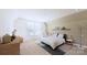 Serene bedroom featuring a comfortable bed, neutral tones, and a cozy seating area by the window at 4609 Firethorn Ct, Denver, NC 28037
