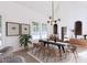 Elegant dining room with modern chandelier, large windows and view of the outside at 4609 Firethorn Ct, Denver, NC 28037