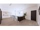 Bright and stylish hallway with modern art, a sleek console table, and a staircase with metal railing at 4609 Firethorn Ct, Denver, NC 28037