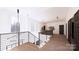 Bright hallway featuring a modern railing, large windows, and a view of the outdoors at 4609 Firethorn Ct, Denver, NC 28037