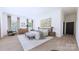 Serene main bedroom with hardwood floors, large windows and a calming color palette at 4609 Firethorn Ct, Denver, NC 28037