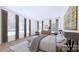 Serene main bedroom featuring hardwood floors and ample natural light from large windows at 4609 Firethorn Ct, Denver, NC 28037