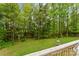 Expansive backyard with mature trees and lush lawn and a playground set, perfect for outdoor activities at 4927 Gateway Dr, Claremont, NC 28610