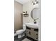 Half bathroom featuring a modern toilet, sink, and shelving for storage at 4927 Gateway Dr, Claremont, NC 28610