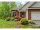 Charming home with brick exterior and lush landscaping around front porch at 4927 Gateway Dr, Claremont, NC 28610
