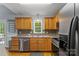 Functional kitchen featuring wood cabinetry, stainless steel appliances, and view to the backyard at 4927 Gateway Dr, Claremont, NC 28610