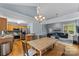 Open-concept eat-in kitchen with stainless appliances and wood cabinets, connected to living room at 4927 Gateway Dr, Claremont, NC 28610