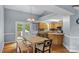 Bright eat-in kitchen with stainless appliances, wood cabinets, and a view of the backyard through French doors at 4927 Gateway Dr, Claremont, NC 28610