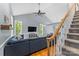 Open-concept living space with hardwood floors, vaulted ceilings, and stairway to second floor at 4927 Gateway Dr, Claremont, NC 28610