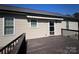 Elevated deck showcasing a convenient access door, surrounded by backyard views at 506 E Pine St, Maiden, NC 28650