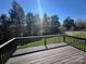 Inviting backyard deck overlooking a beautiful grassy lawn surrounded by mature trees on a sunny day at 506 E Pine St, Maiden, NC 28650