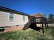 Exterior of home featuring a wooden deck, awning and lawn with stairs at 506 E Pine St, Maiden, NC 28650