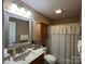 Clean bathroom with a neutral color scheme, vanity sink, and patterned shower curtain at 506 E Pine St, Maiden, NC 28650