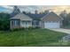 Charming brick and vinyl home with well-maintained lawn and attached two-car garage at 506 E Pine St, Maiden, NC 28650