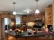 Well-lit kitchen with stainless steel appliances, wood cabinets, and stone countertops at 506 E Pine St, Maiden, NC 28650