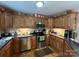 Functional kitchen with wood cabinets, stainless steel appliances, and hardwood flooring at 506 E Pine St, Maiden, NC 28650