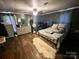 This bedroom features wood floors, a ceiling fan, and a bed with pillows at 548 Alspaugh Dam Rd, Taylorsville, NC 28681