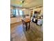 Well-lit kitchen featuring white cabinets, stainless steel appliances, and a wooden dining table at 548 Alspaugh Dam Rd, Taylorsville, NC 28681
