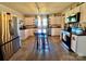 Bright kitchen with white cabinetry, stainless steel appliances and a wooden dining table at 548 Alspaugh Dam Rd, Taylorsville, NC 28681