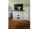 Cozy living room with a brick fireplace and wood flooring at 548 Alspaugh Dam Rd, Taylorsville, NC 28681
