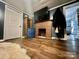 Cozy living room with a brick fireplace and wooden flooring at 548 Alspaugh Dam Rd, Taylorsville, NC 28681