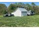 A truck and a camper are parked near a barn, offering space and function at 548 Alspaugh Dam Rd, Taylorsville, NC 28681