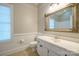 Bathroom featuring wainscoting, white vanity, framed mirror, and tile flooring at 6007 Kenmore Ln, Indian Trail, NC 28079