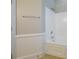 Bathroom featuring tub with shower, wainscoting, and tile flooring at 6007 Kenmore Ln, Indian Trail, NC 28079